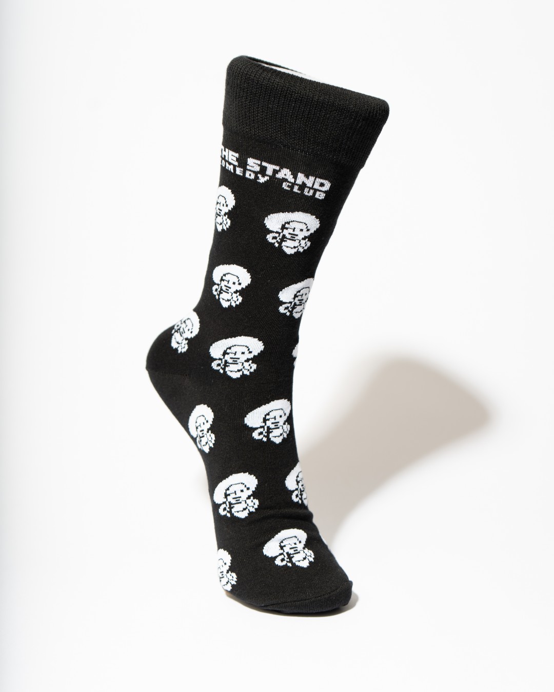 Black Stand Comedy Club sock with repeated mascot artwork